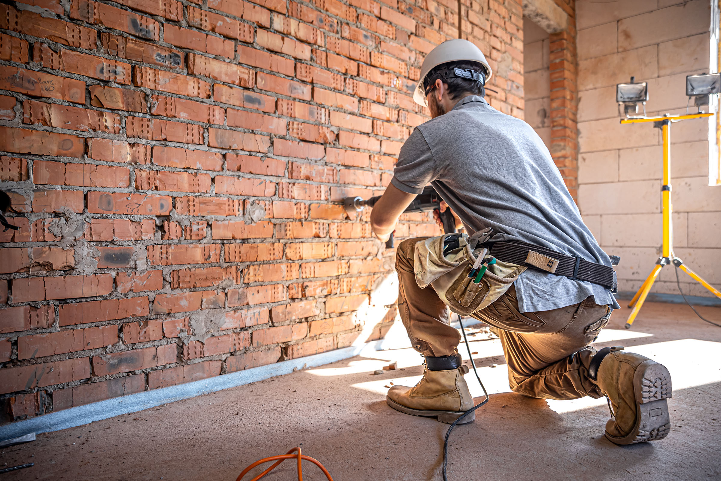 Interior contractor drilling the wall